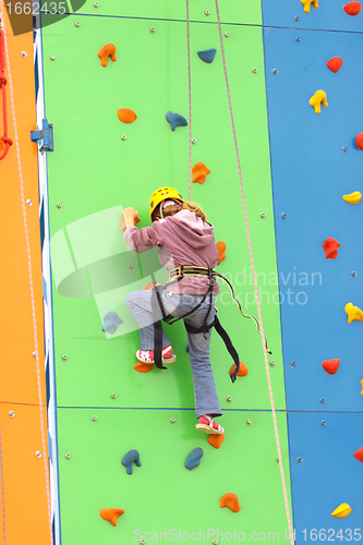 Image of Child climbing on a climbing wall, outdoor