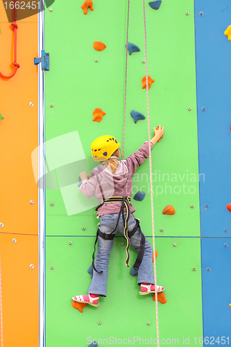 Image of Child climbing on a climbing wall, outdoor