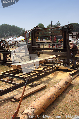 Image of old machine to saw the logs of wood in France