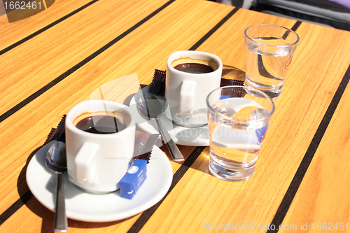 Image of cups of coffee with a glass of water