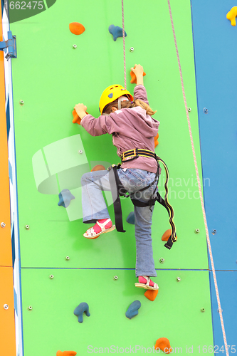 Image of Child climbing on a climbing wall, outdoor