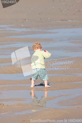 Image of Children playing with sand on the beach