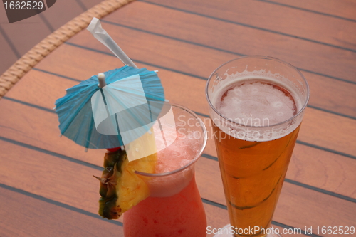 Image of glass of fruit cocktail and a glass of beer
