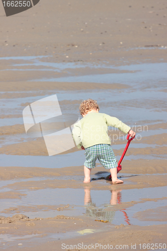 Image of Children playing with sand on the beach