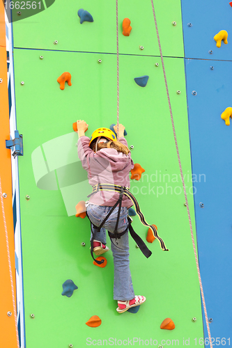 Image of Child climbing on a climbing wall, outdoor