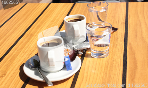 Image of cups of coffee with a glass of water