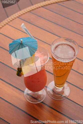 Image of glass of fruit cocktail and a glass of beer