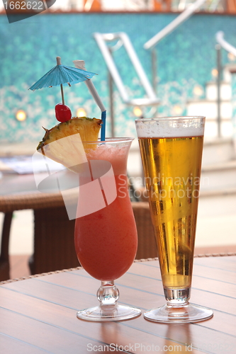 Image of glass of fruit cocktail and a glass of beer