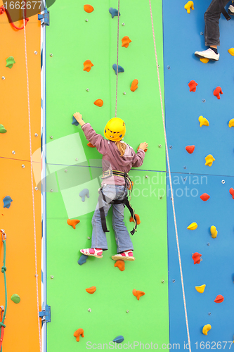 Image of Child climbing on a climbing wall, outdoor