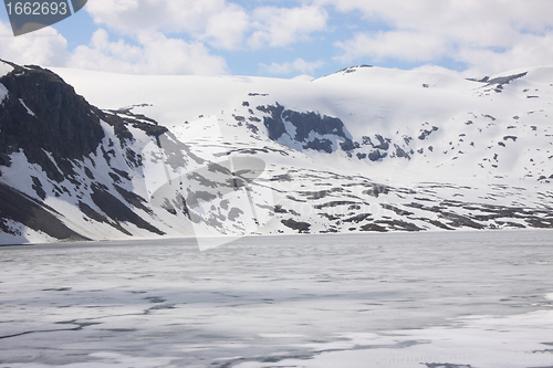 Image of frozen lake and snowy mountains in norway