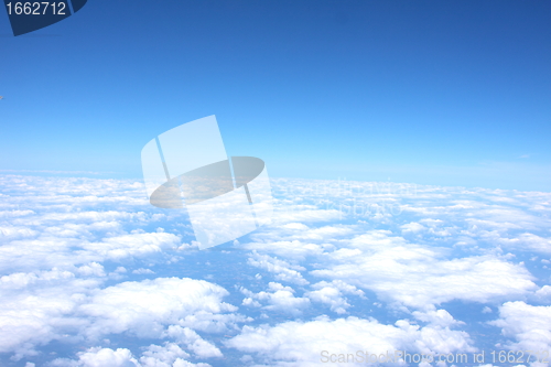 Image of clouds and blue sky seen from plane