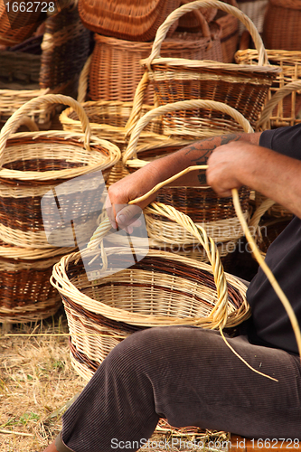 Image of Details of the manufacturing of wicker baskets by a man