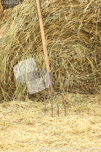 Image of pitchfork standing on a pile of straw