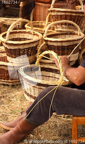 Image of Details of the manufacturing of wicker baskets by a man