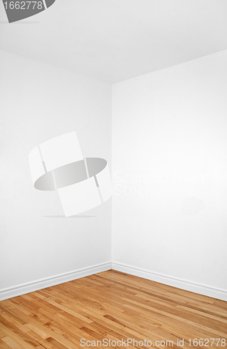 Image of Empty corner of a room with wooden floor