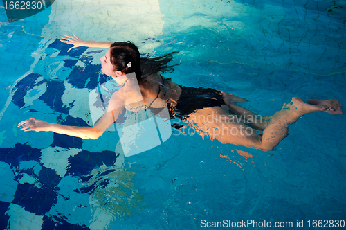 Image of Attractive girl in swimming pool