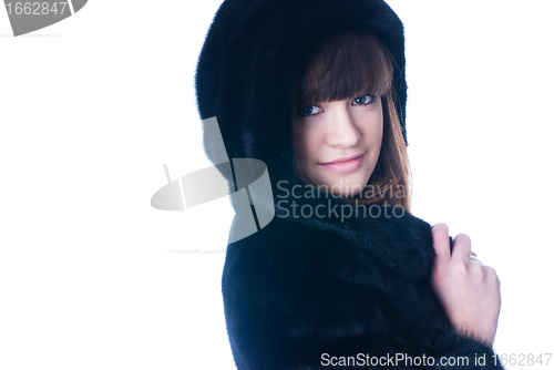 Image of Young woman in fur coat