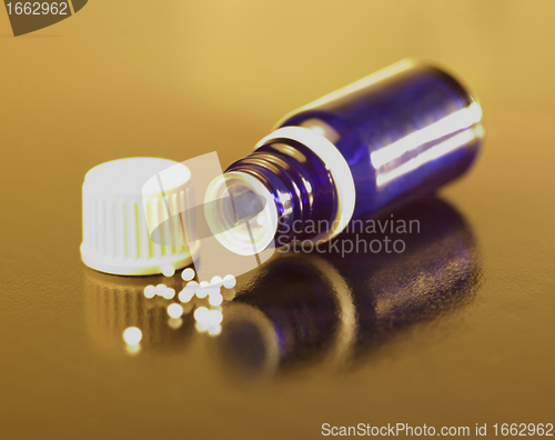 Image of small bottle and globules