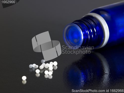 Image of small bottle and globules