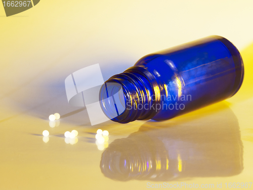 Image of small bottle and globules