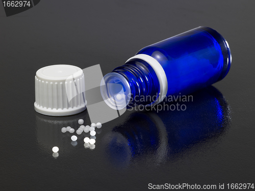 Image of small bottle and globules