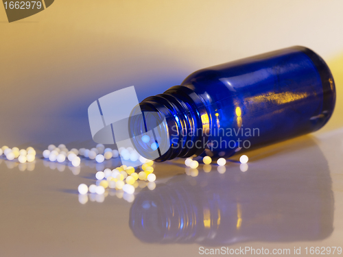 Image of small bottle and globules