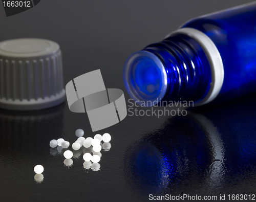 Image of small bottle and globules