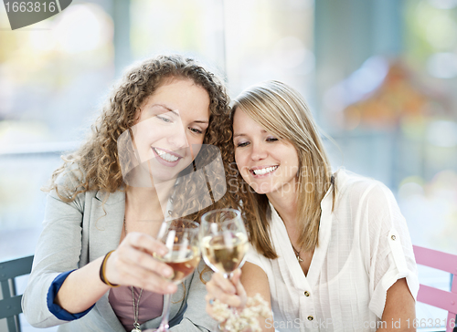 Image of Women toasting with white wine