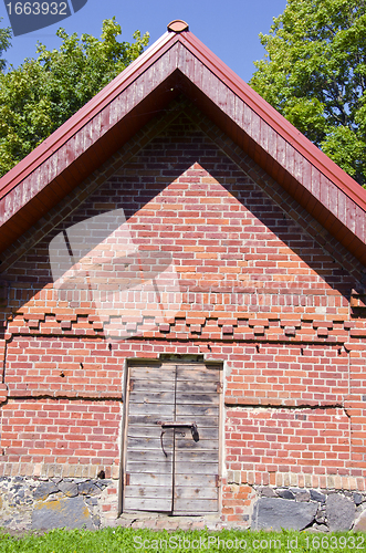 Image of Rural farm building of brick wooden doors padlock 