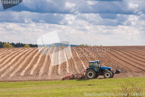 Image of tractor plowing filed