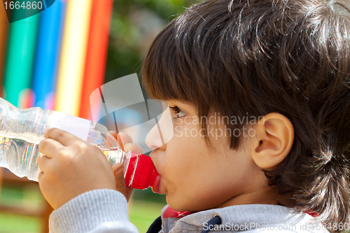 Image of little boy drinking pure water