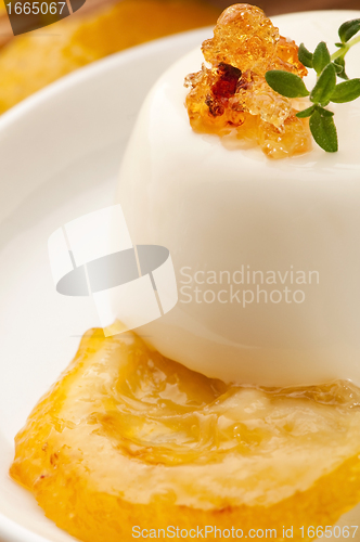 Image of Vanilla Panna Cotta Dessert with lemon and fresh herbs