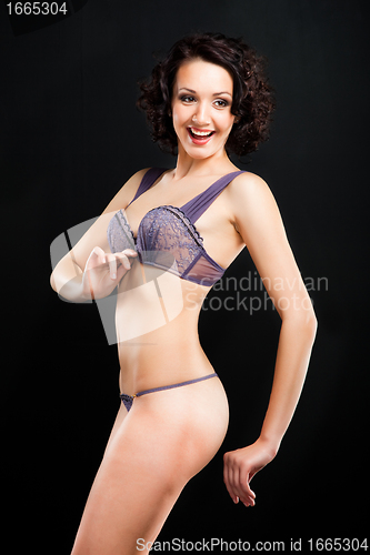 Image of girl in lacy underwear on black background