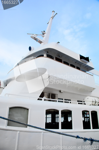 Image of White tourist ship close up on blue sky