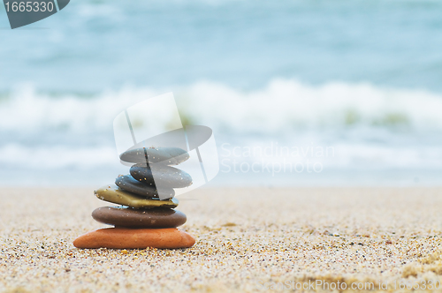 Image of Stack of beach stones on sand