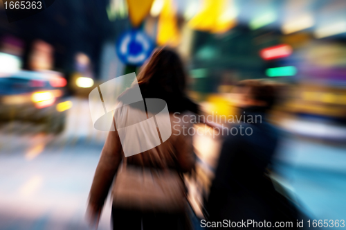 Image of Two women at city centre at night