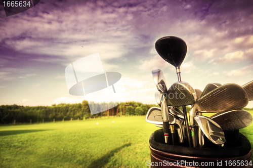 Image of Golf gear, clubs at sunset