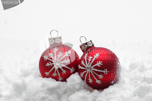 Image of Red Christmas balls in snow