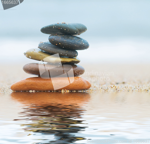 Image of Stack of beach stones on sand