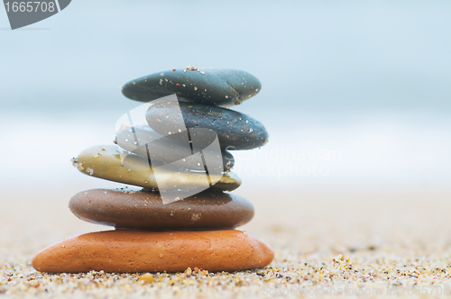 Image of Stack of beach stones on sand