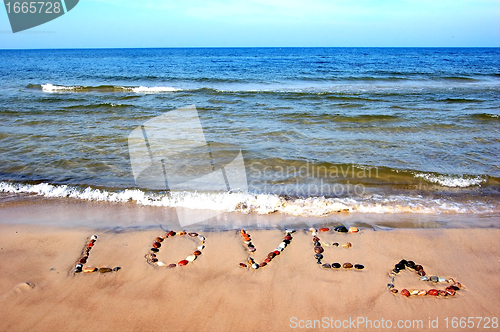 Image of Word LOVE on beach sand