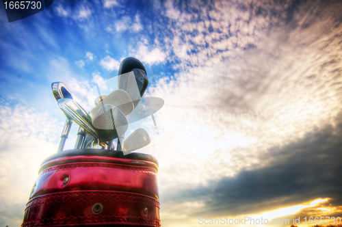 Image of Golf gear, clubs at sunset