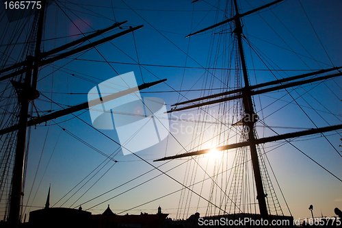 Image of Ship sails silhouette at sunset