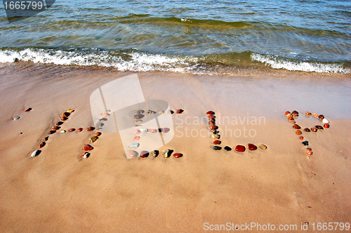 Image of Word HELP on beach sand