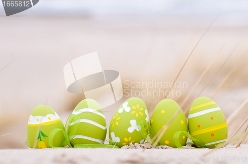 Image of Easter decorated eggs on sand