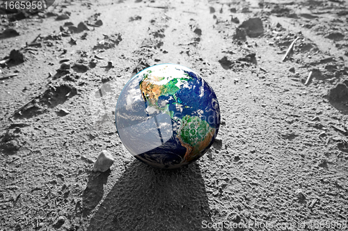 Image of The Earth globe on rocky Mars like surface