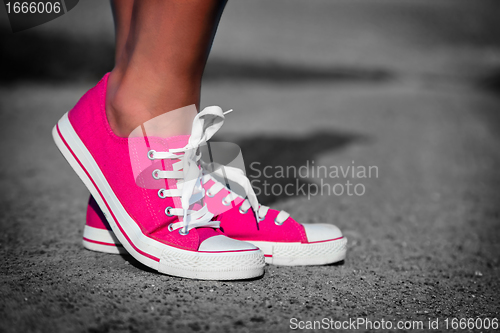 Image of Pink sneakers on girl, woman legs