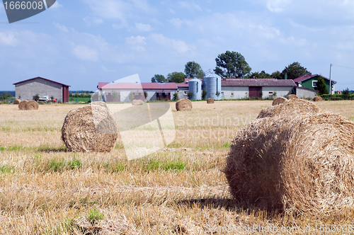 Image of Farm buildings and haystacks