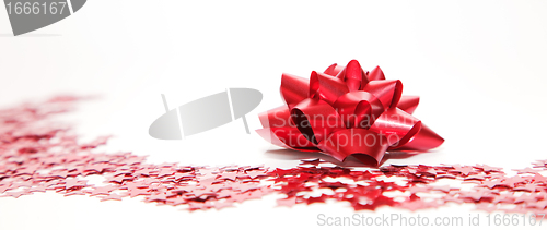 Image of Christmas decoration, red ribbon and stars