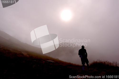 Image of Man and foggy mountains
